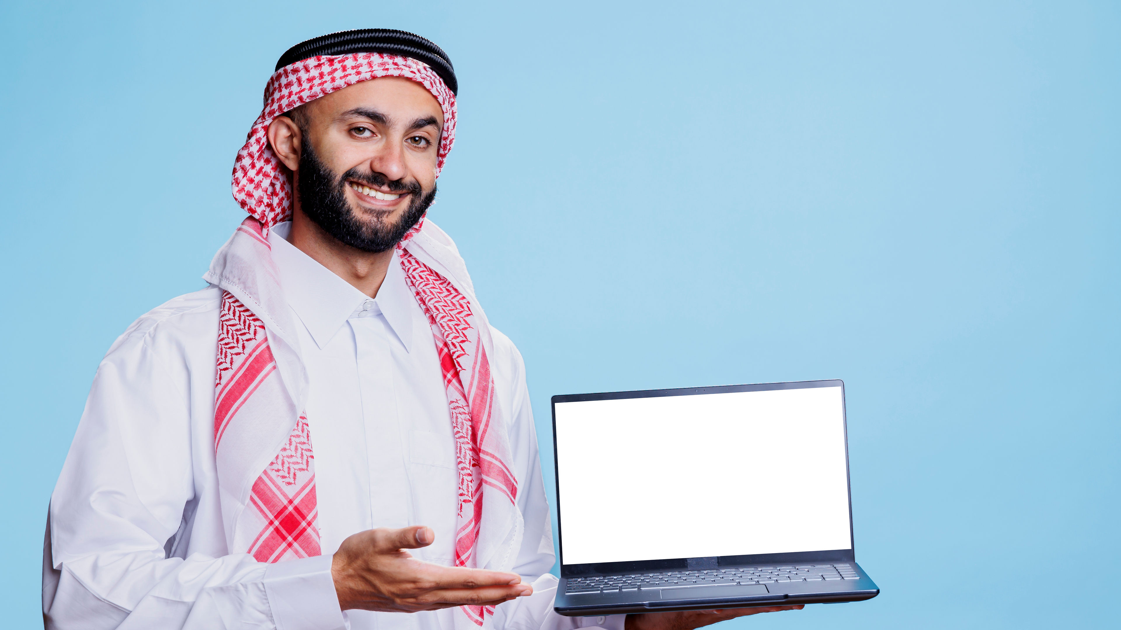 Muslim man showing laptop