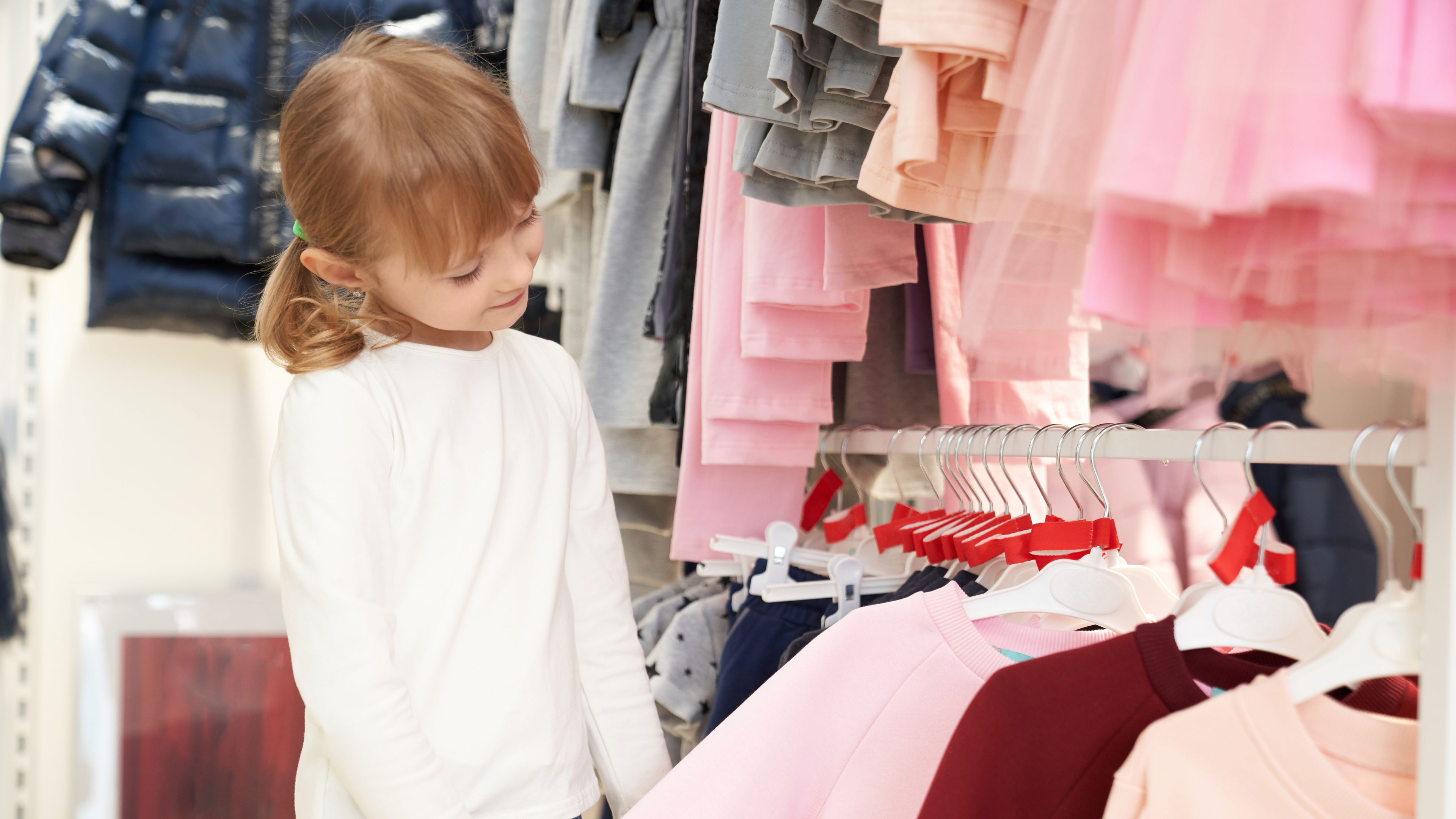 Pretty child is choosing clothes