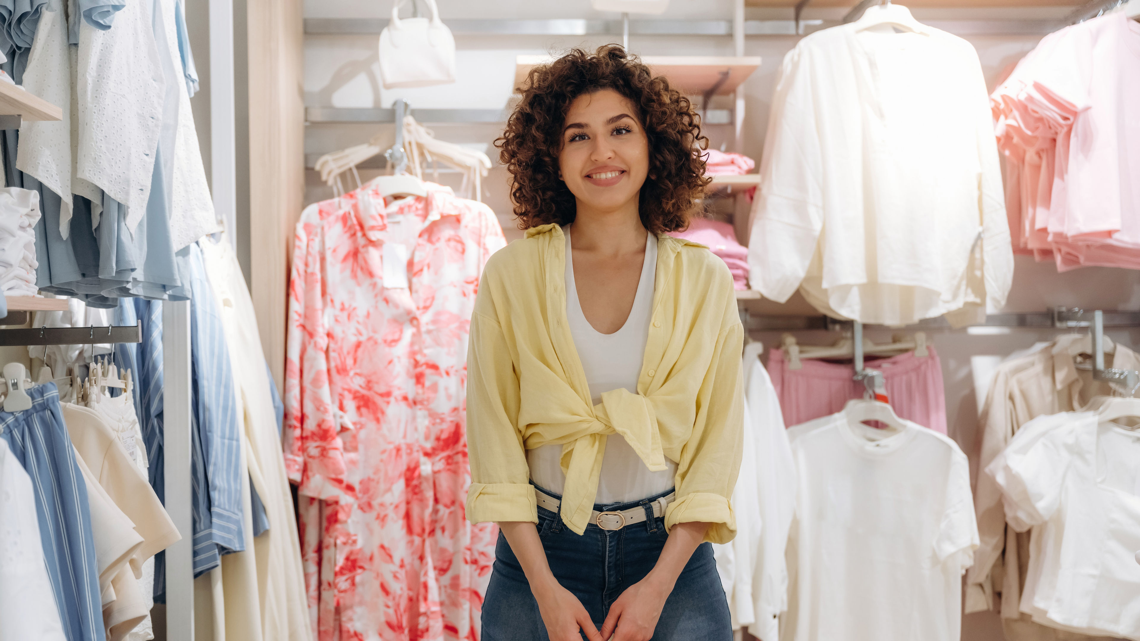 Smiling Woman Shopping for Clothes in Clothing Store