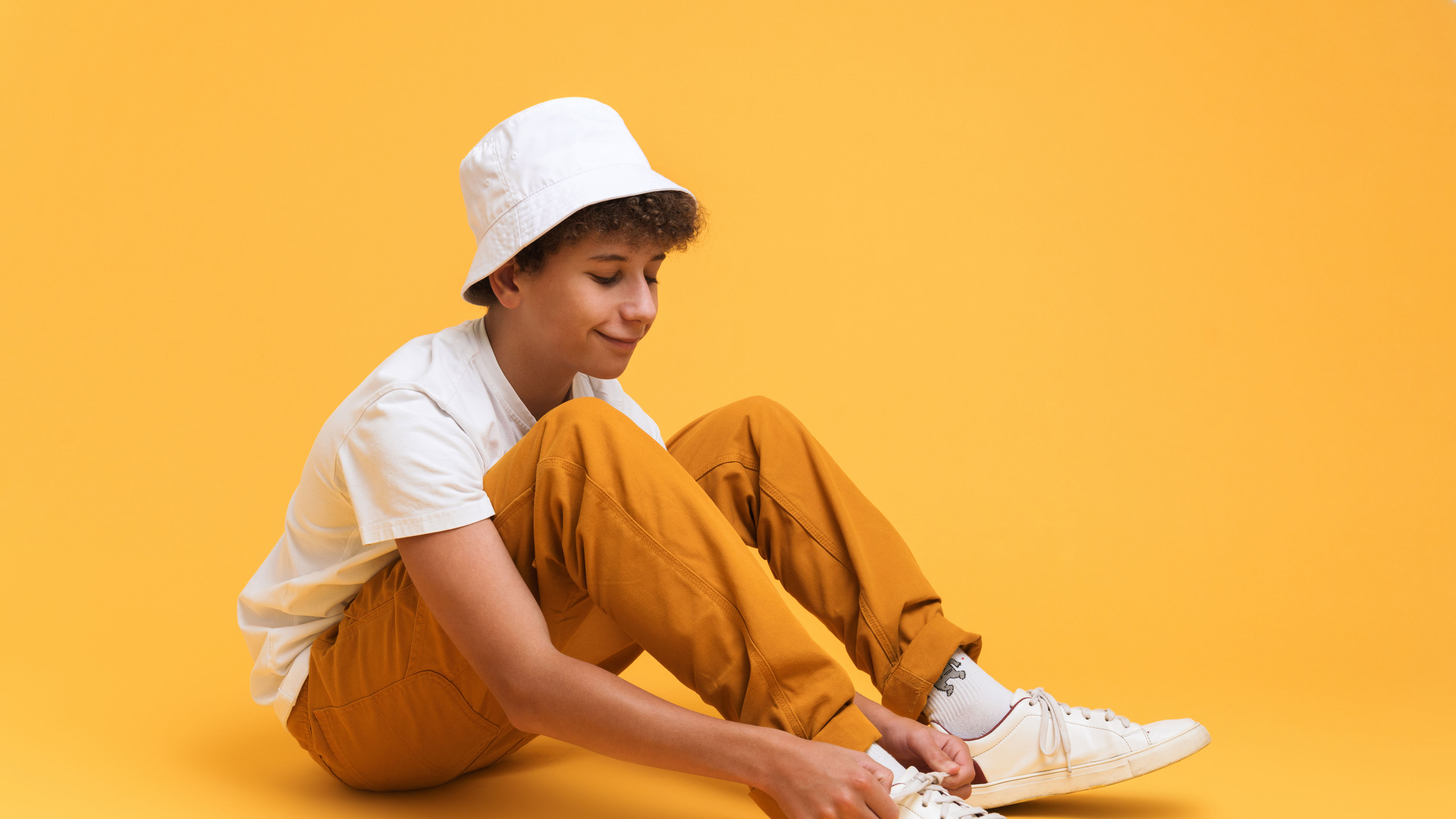  A boy tying the shoe lace