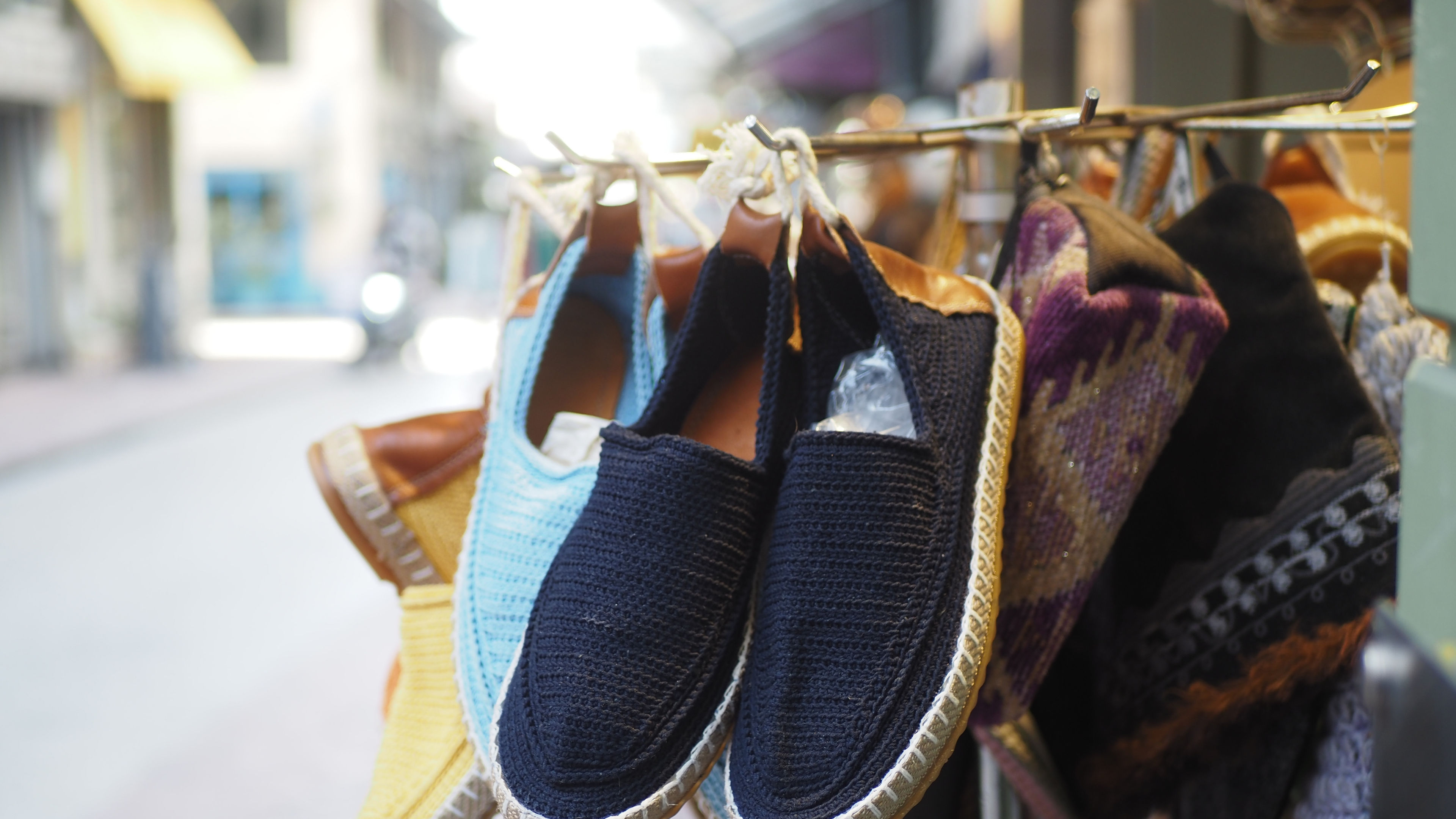 A display of colorful espadrilles hanging on hooks