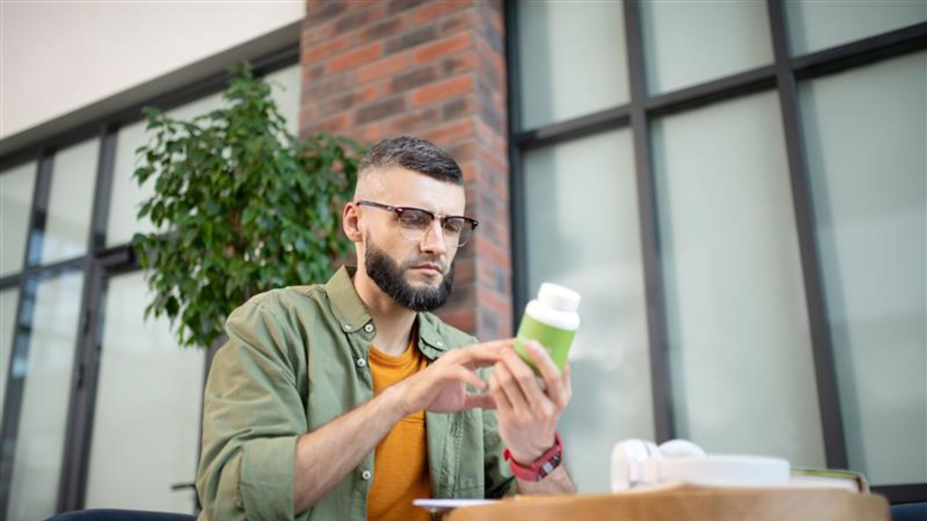 A man looking at some pills