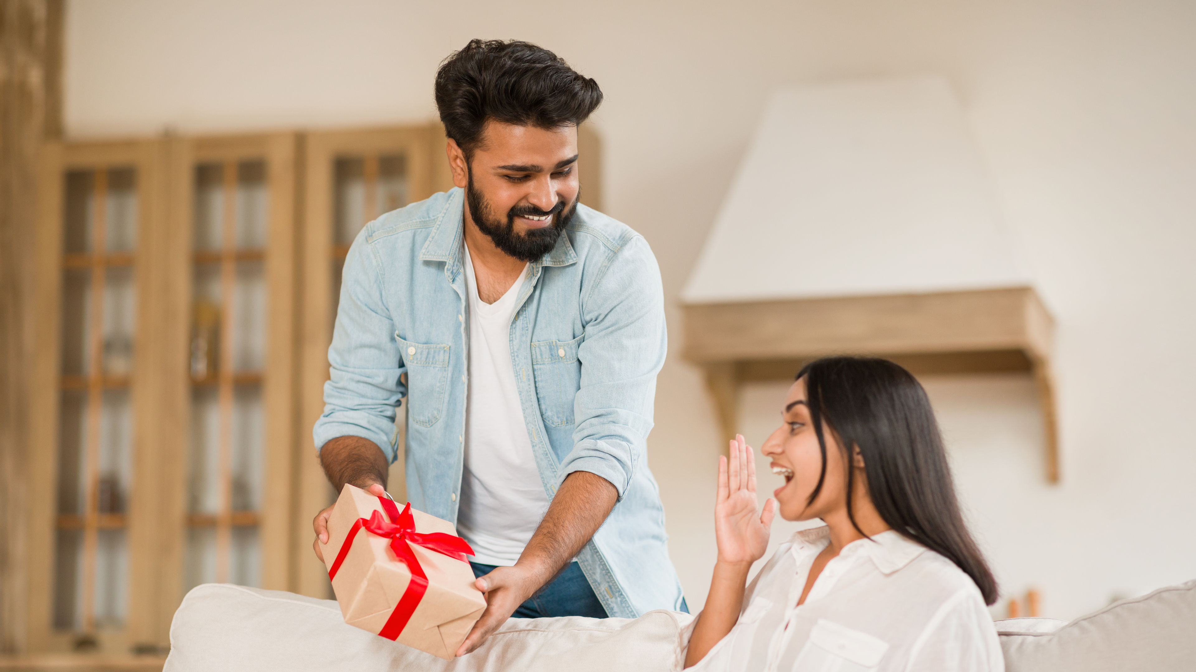 A man surprises his girlfriend with a gift