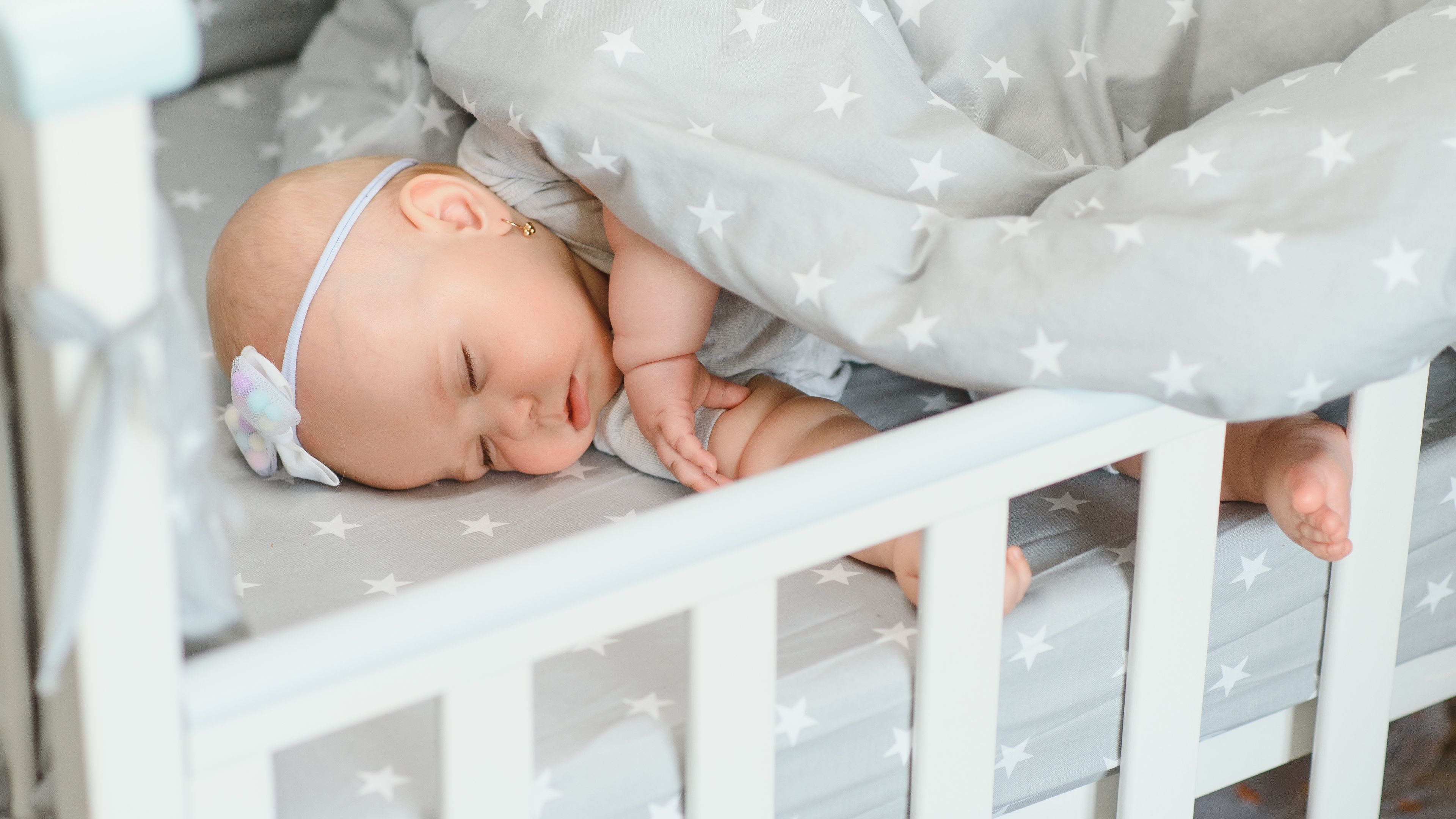 Baby girl sleeping in the crib