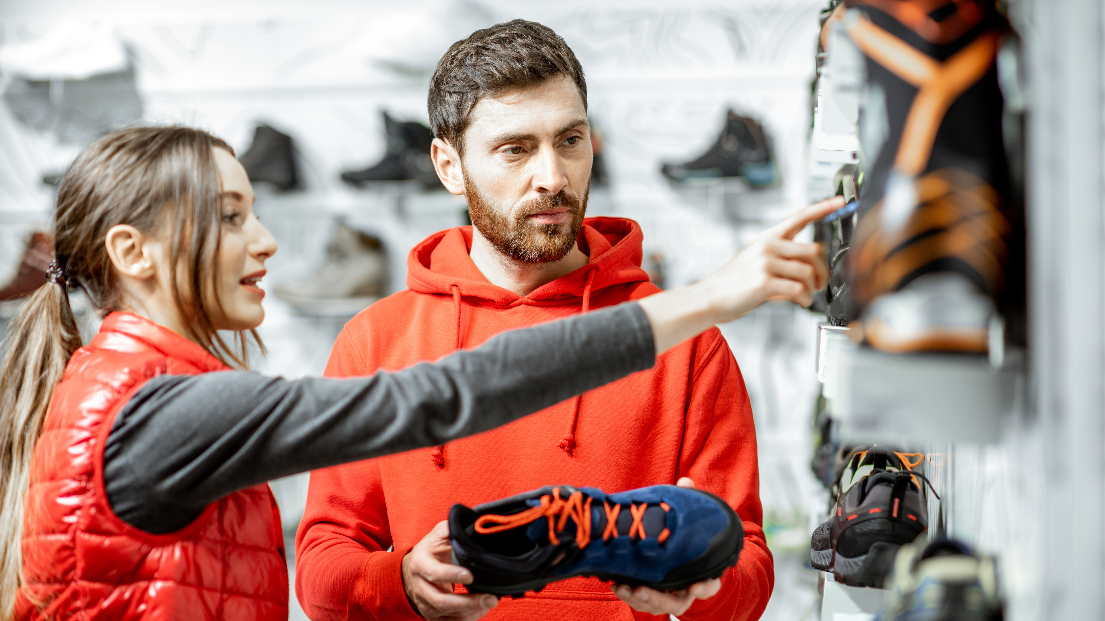 Man and woman choosing shoes in the shop