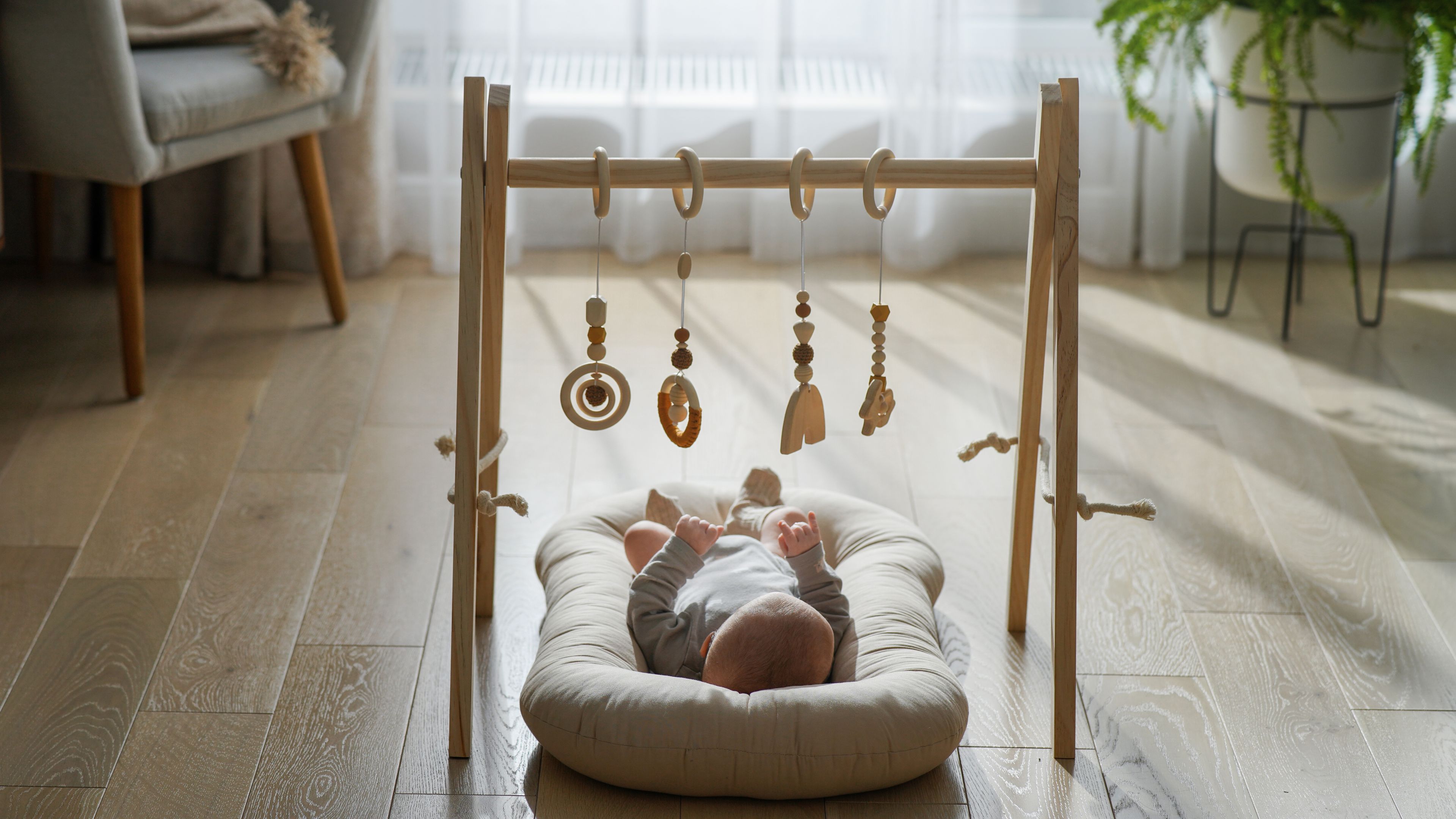 Newborn playing in a cradle