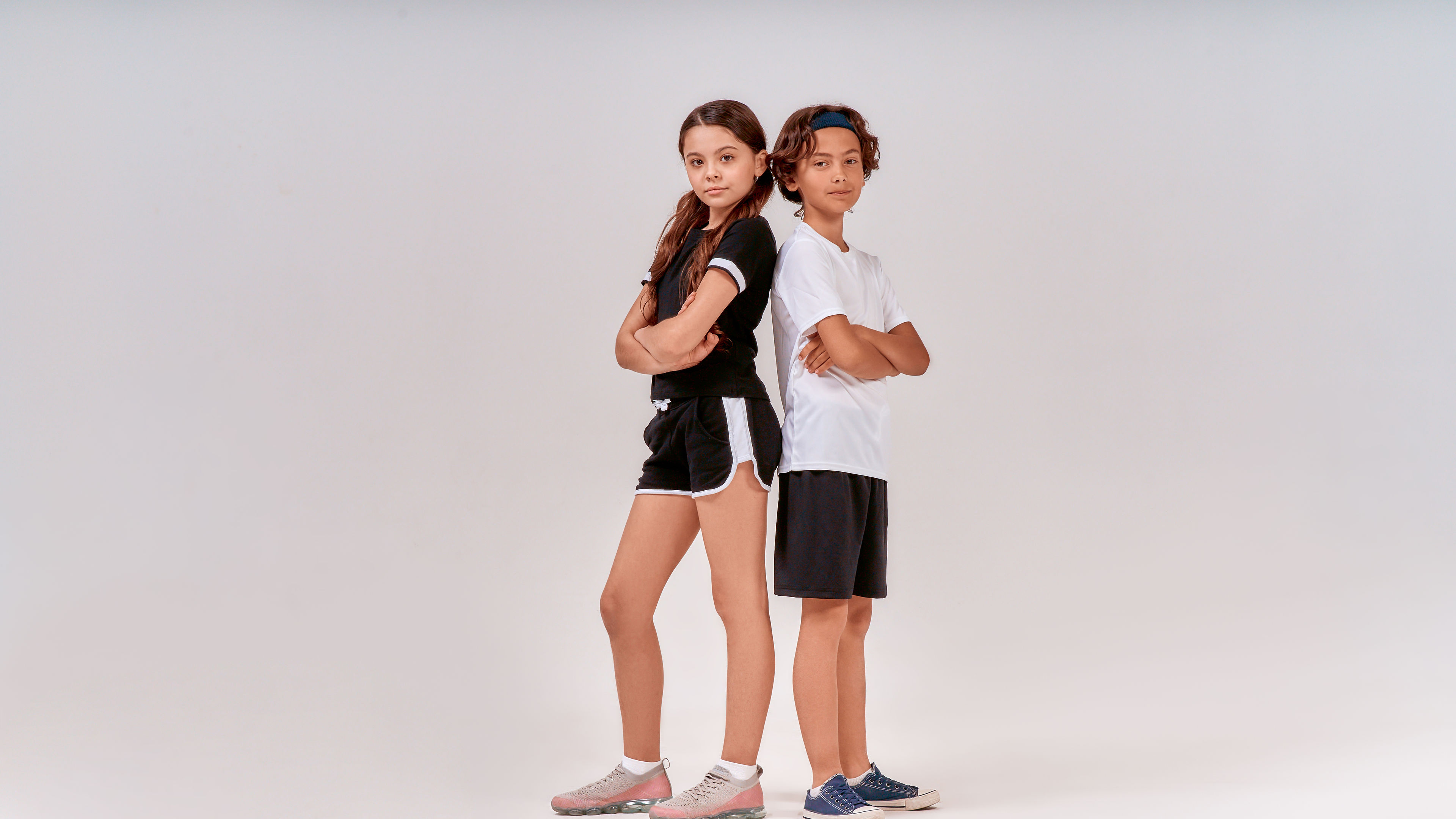 Two kids in sports apparel