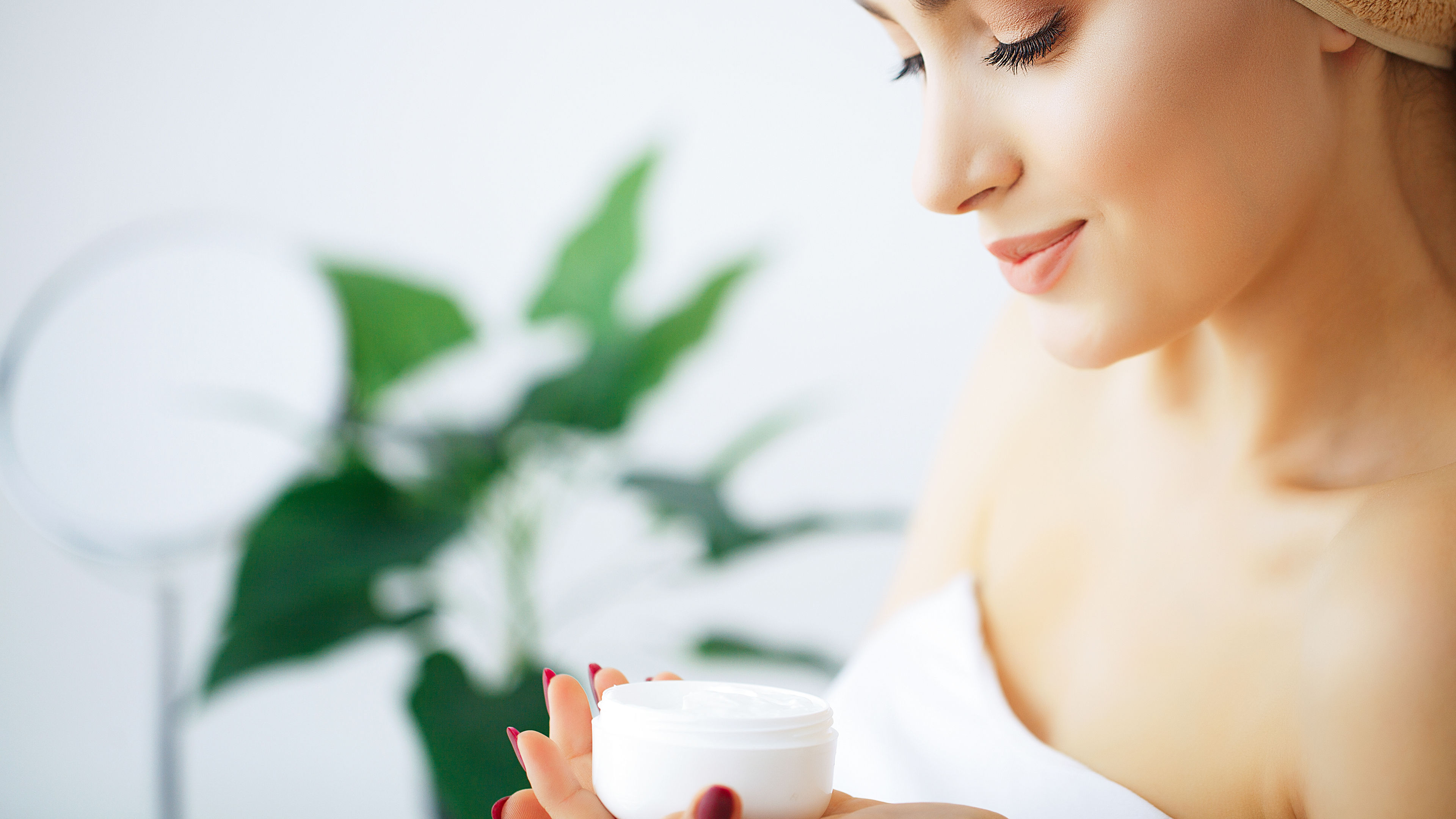 Woman applying face cream