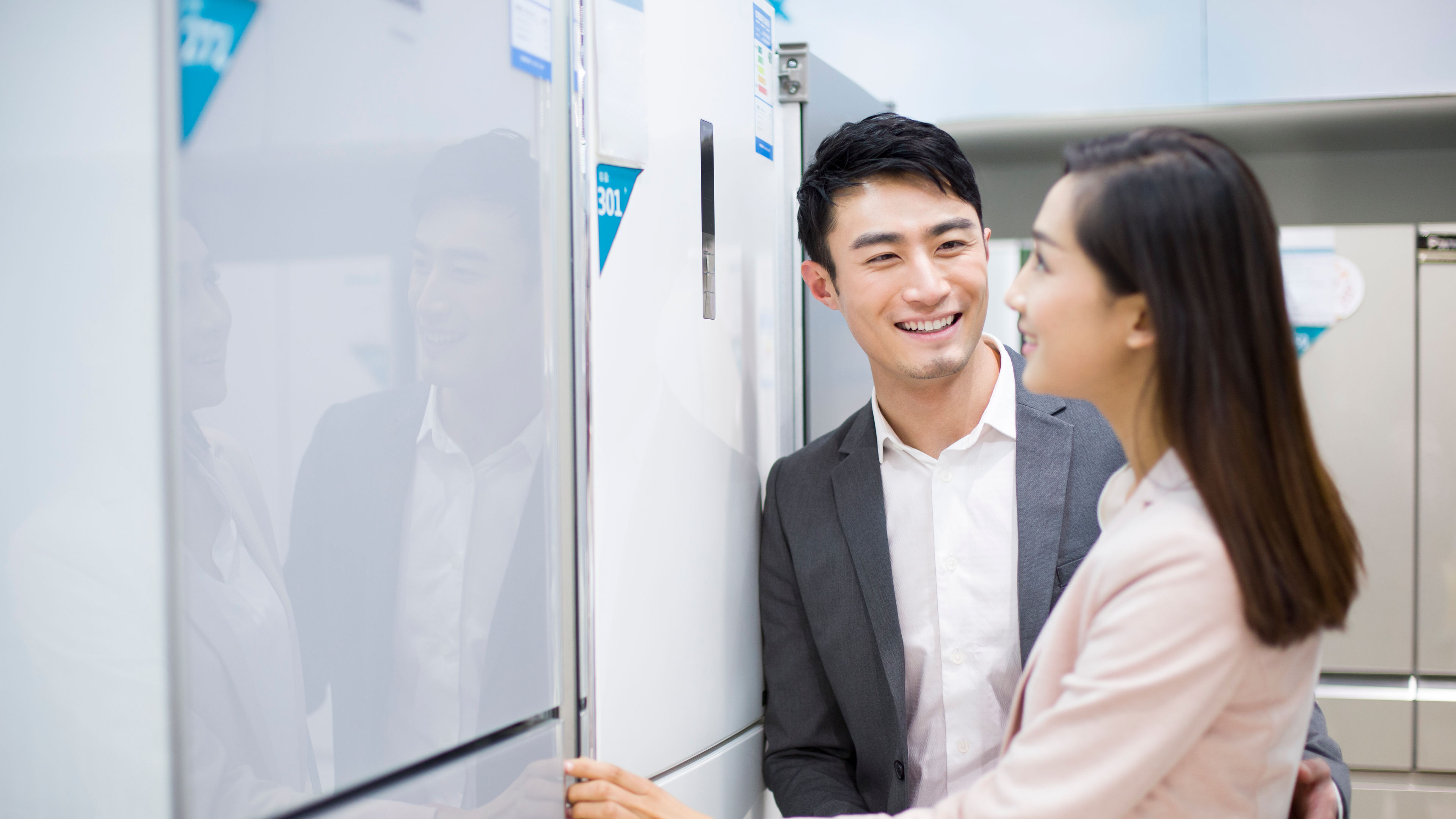 Young Couple buying refrigerator